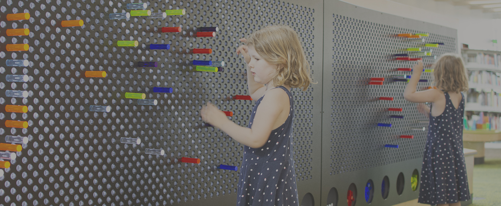 girl playing with a giant light bright